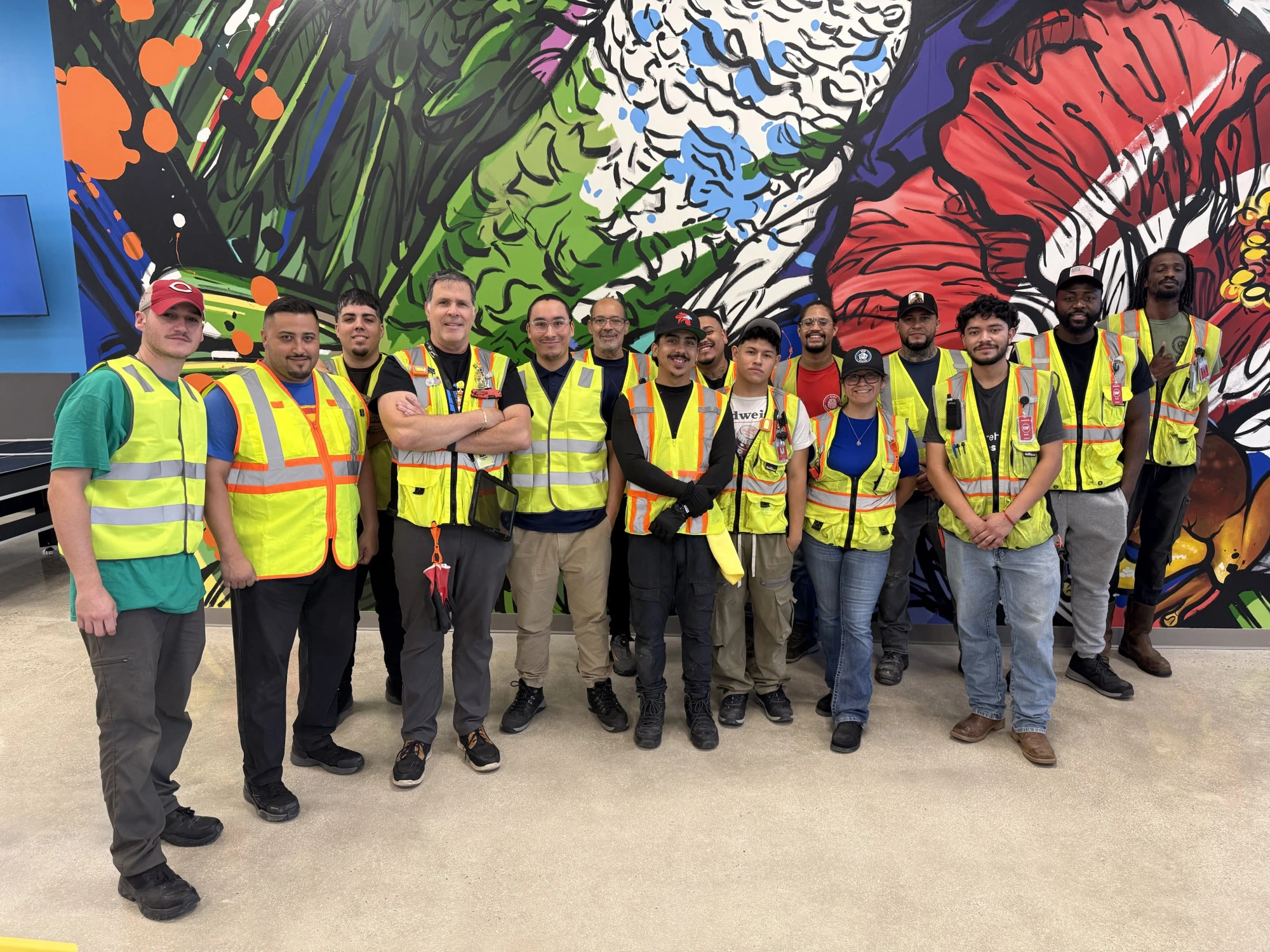The MOCA crew in Puerto Rico in front of a colorful mural