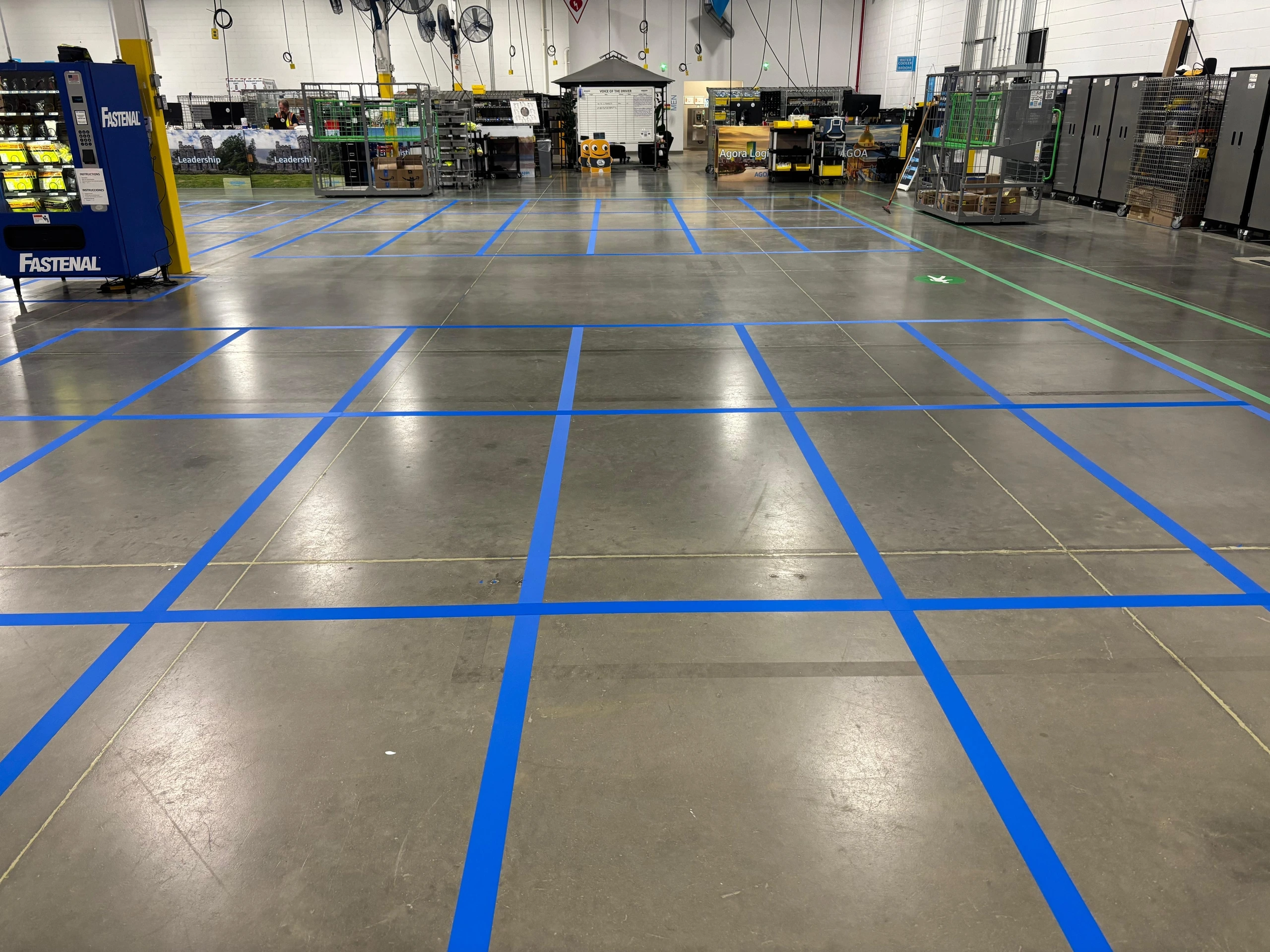 A reconfigured floor with a fresh 5S grid marked in blue tape